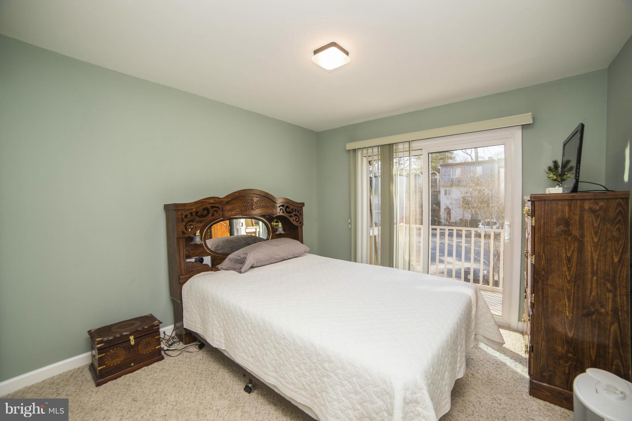 1613 Valencia Way Reston, VA 20190 - Photo 15 of 29 a bedroom with a bed and a large window