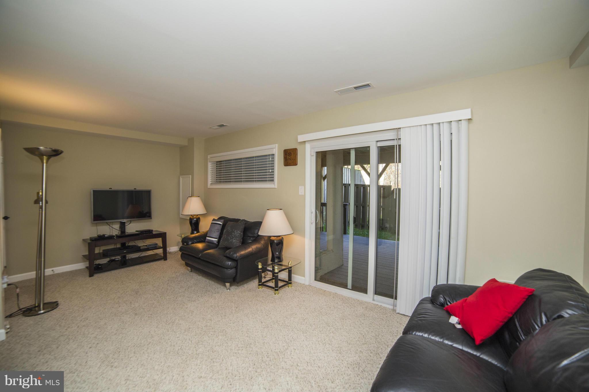 1613 Valencia Way Reston, VA 20190 - Photo 21 of 29 a living room with furniture and a flat screen tv