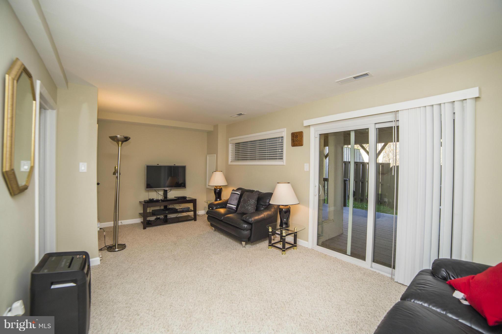 1613 Valencia Way Reston, VA 20190 - Photo 22 of 29 a living room with furniture and a flat screen tv