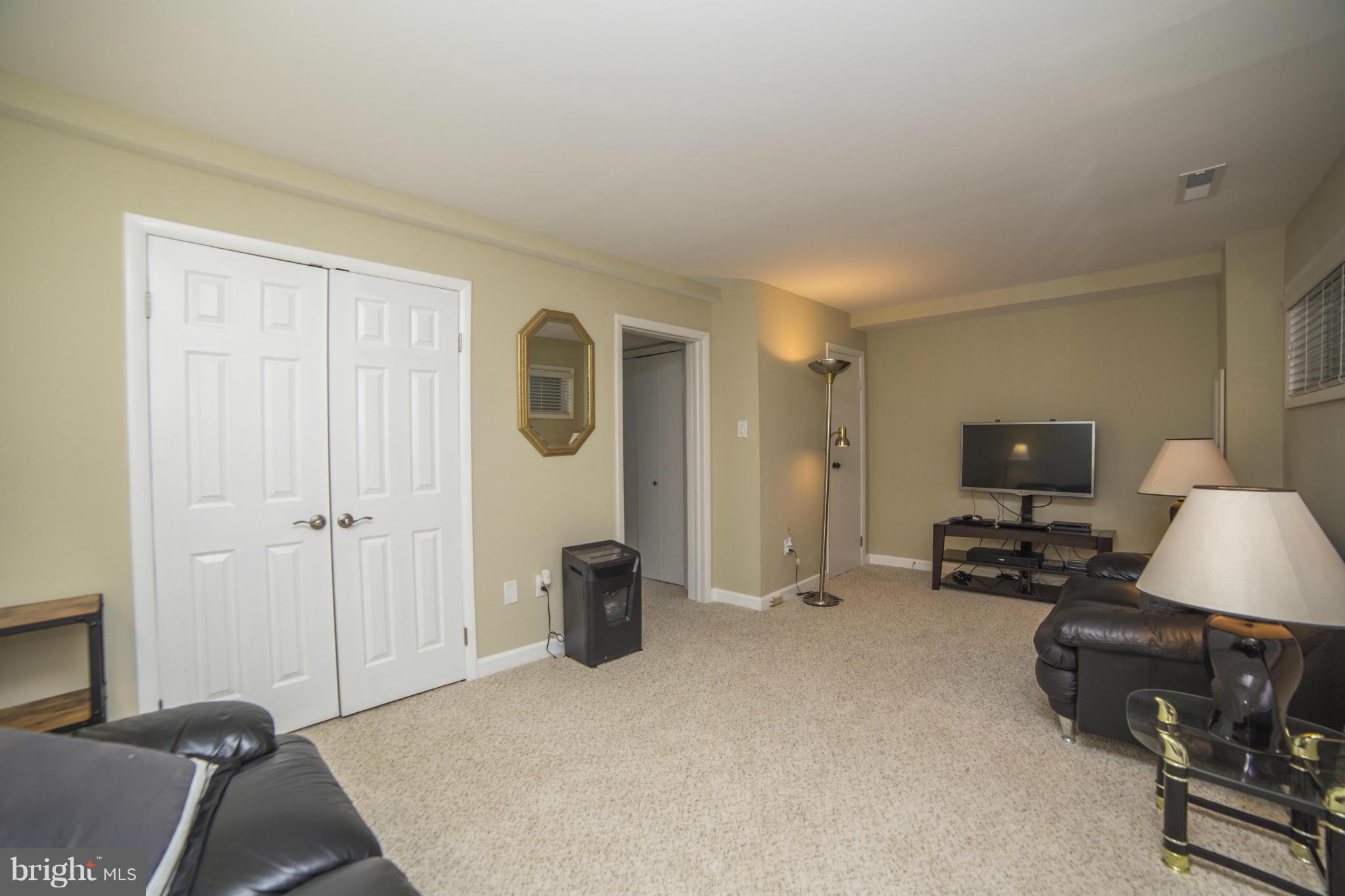 1613 Valencia Way Reston, VA 20190 - Photo 23 of 29 a bedroom with furniture and a flat screen tv