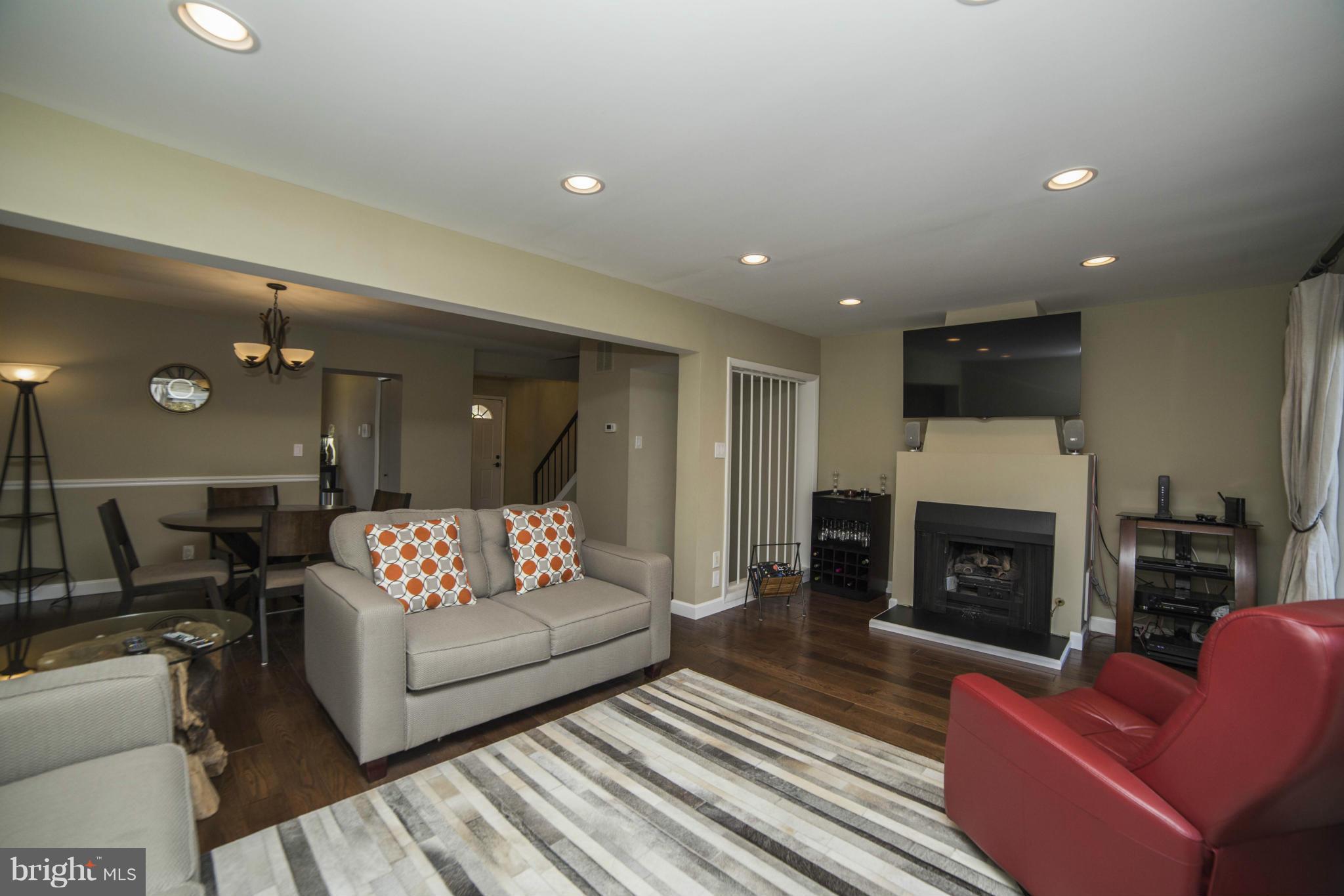 1613 Valencia Way Reston, VA 20190 - Photo 5 of 29 a living room with furniture and a fireplace