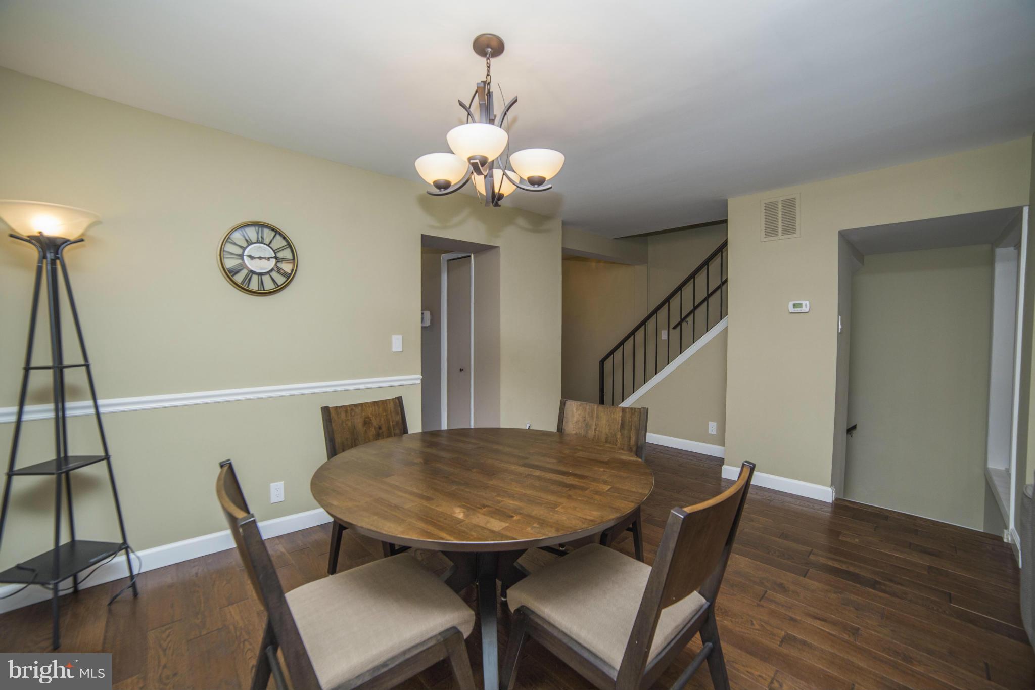 1613 Valencia Way Reston, VA 20190 - Photo 7 of 29 a view of a dining room with furniture and wooden floor