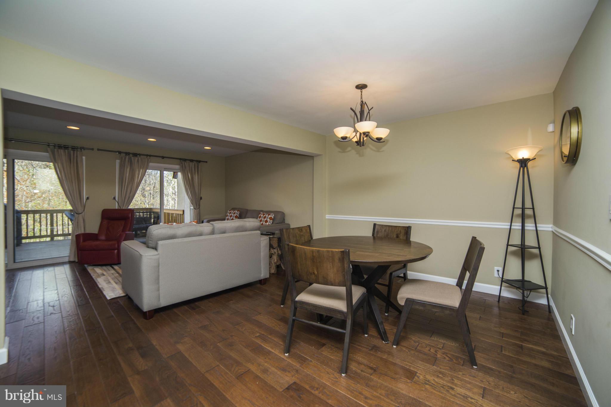 1613 Valencia Way Reston, VA 20190 - Photo 8 of 29 a living room with furniture and a chandelier