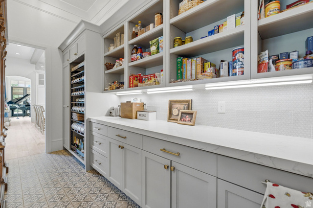71 Farm Road Midway, UT 84049 - Photo 14 of 92 Custom pantry featuring extensive built-in shelving, a dedicated wine refrigeration unit, and a white countertop
