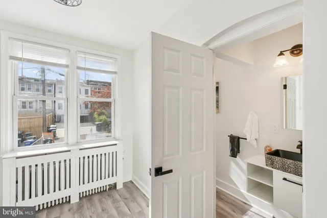 a bathroom with a granite countertop sink a mirror and a shower