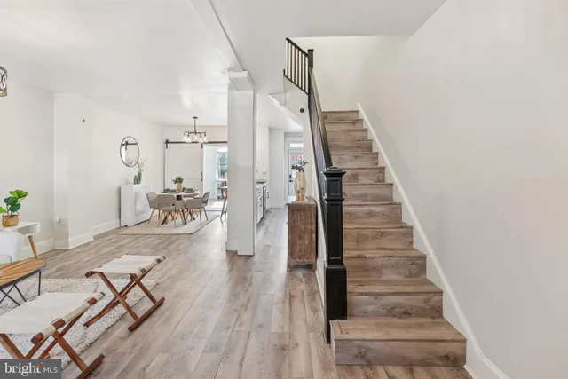 a view of entryway and hall with wooden floor