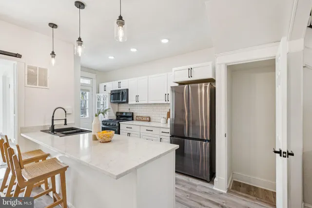 a kitchen with refrigerator and cabinets