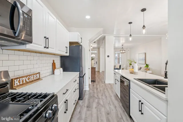 a kitchen with a sink stove and refrigerator