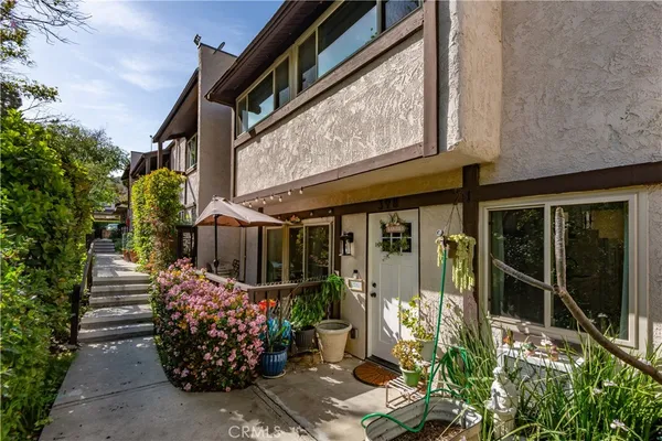 a view of a pathway with a potted plants