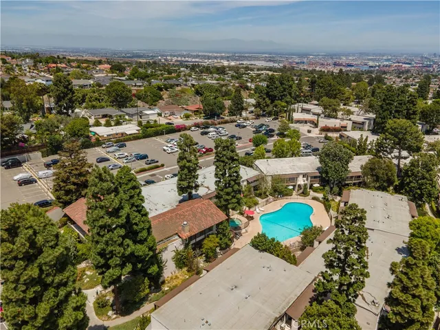 a kitchen with stainless steel appliances kitchen island a table and chairs in it