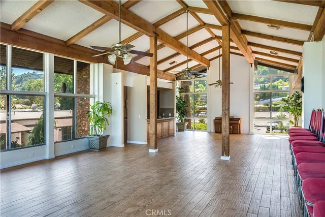 a view of interior space with wooden floor and windows