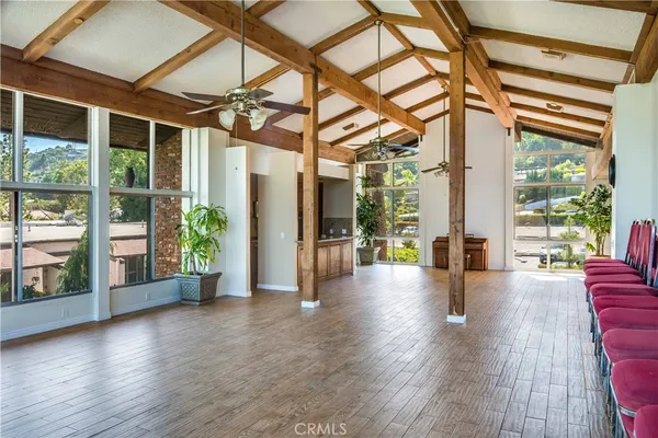 a view of interior space with wooden floor and windows