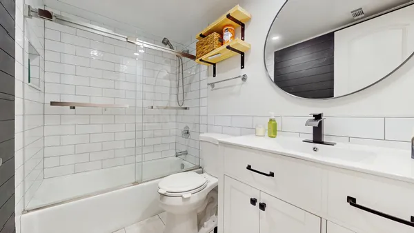 a bathroom with a sink a toilet and shower