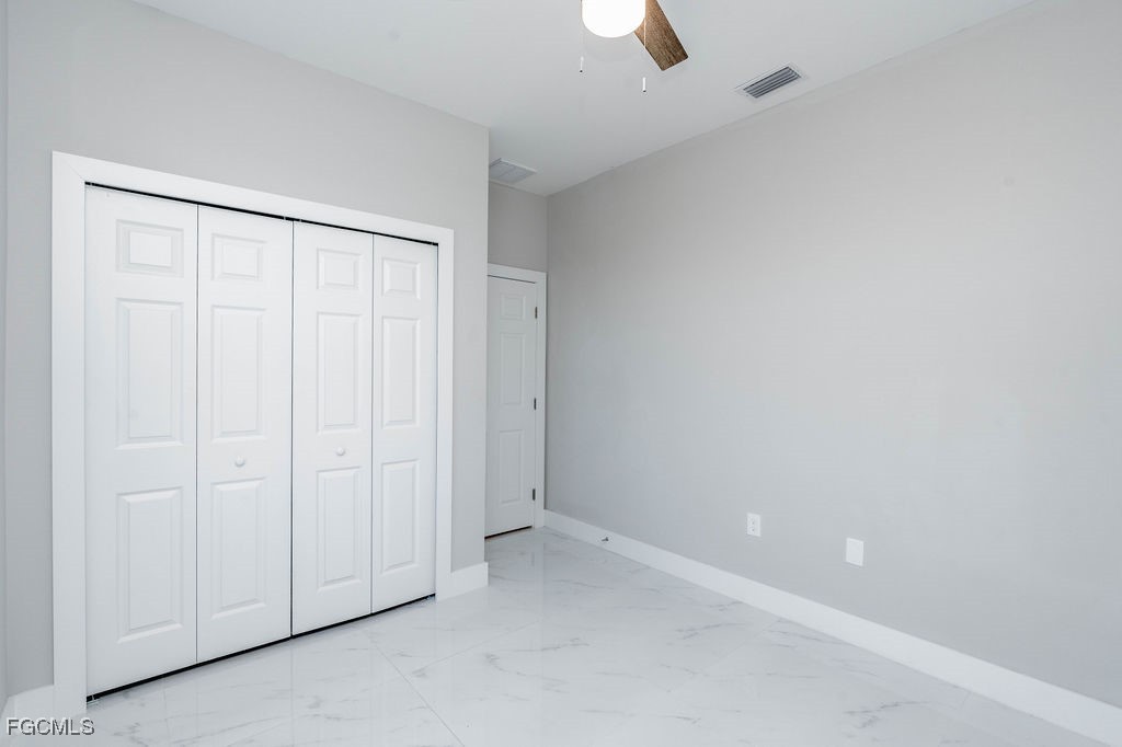 4417 22nd Street Southwest Lehigh Acres, FL 33973 - Photo 11 of 36 an empty room with a empty space and windows