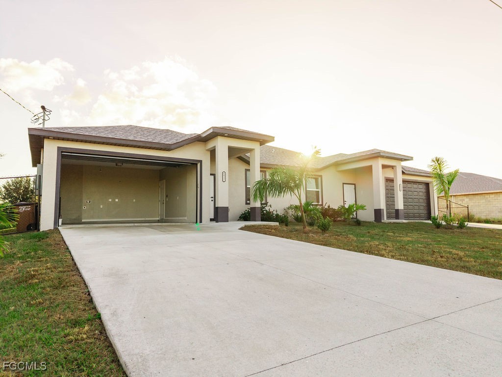4417 22nd Street Southwest Lehigh Acres, FL 33973 - Photo 20 of 36 front view of a house with a yard