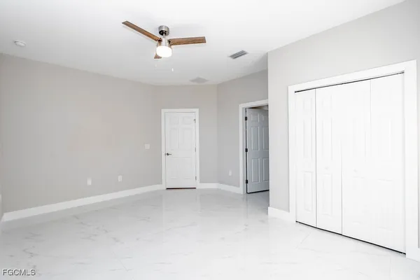 an empty room with a ceiling fan