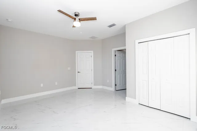 an empty room with a ceiling fan