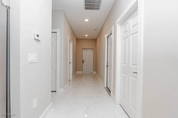 a large white kitchen with cabinets