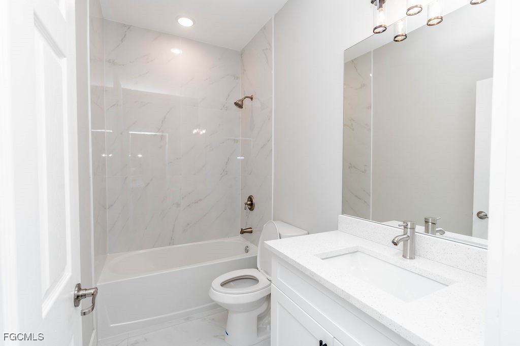 4417 22nd Street Southwest Lehigh Acres, FL 33973 - Photo 28 of 36 a bathroom with a sink a toilet and shower