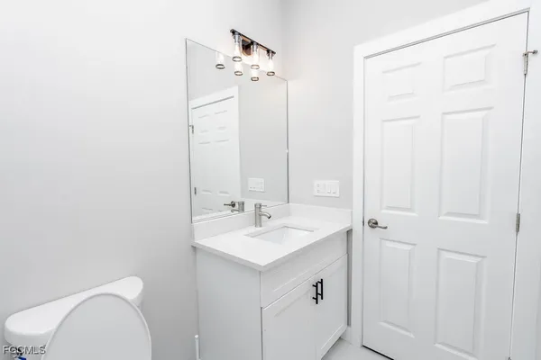 a kitchen with stainless steel appliances a sink dishwasher stove and white cabinets