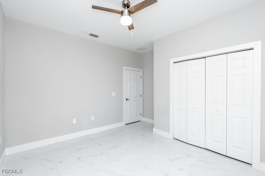 4417 22nd Street Southwest Lehigh Acres, FL 33973 - Photo 30 of 36 an empty room with a ceiling fan