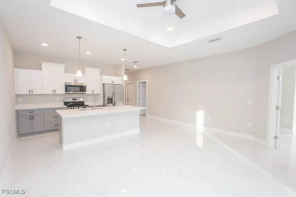 an empty room with a window and a ceiling fan