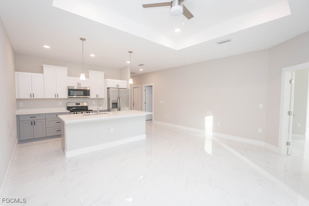 4417 22nd Street Southwest Lehigh Acres, FL 33973 - Photo 31 of 36 a large white kitchen with cabinets