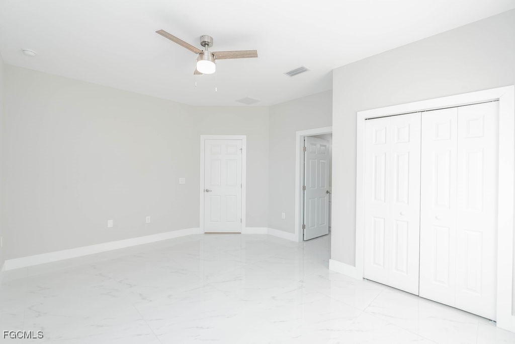 4417 22nd Street Southwest Lehigh Acres, FL 33973 - Photo 34 of 36 an empty room with a ceiling fan and a window
