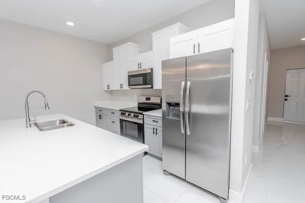 an empty room with a window and a ceiling fan