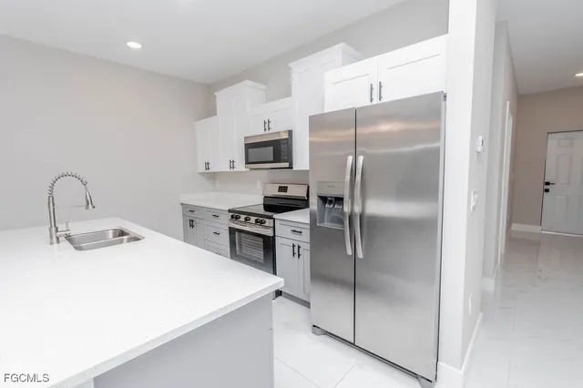 an empty room with a window and a ceiling fan