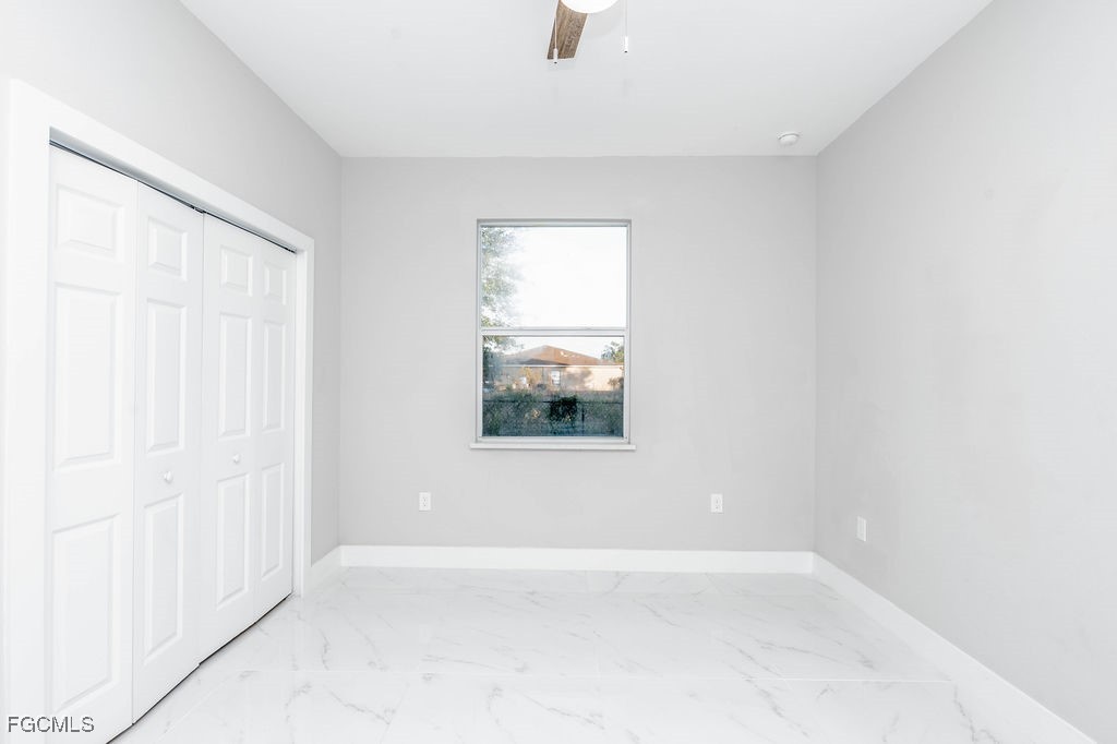 4417 22nd Street Southwest Lehigh Acres, FL 33973 - Photo 7 of 36 an empty room with windows