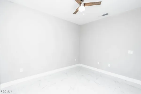 an empty room with a empty space and windows