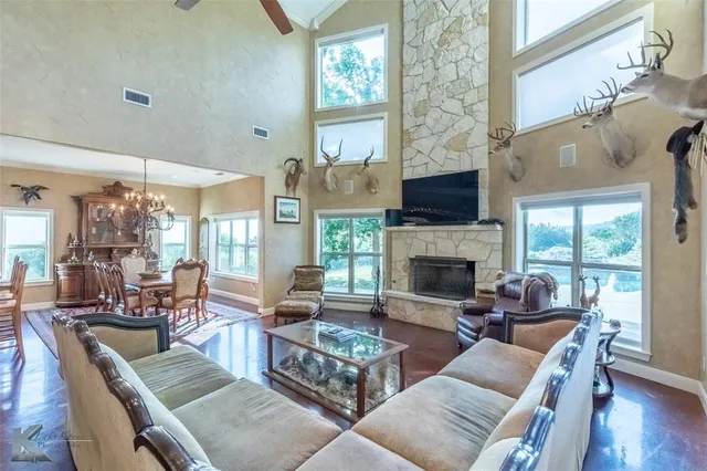 a living room with furniture a fireplace and a large window