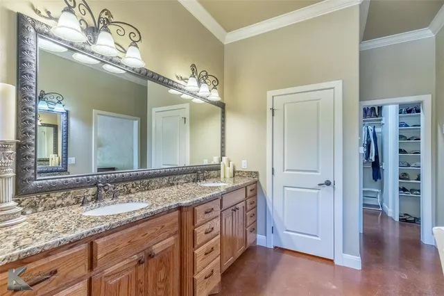 a spacious bathroom with a granite countertop sink a mirror and a shower
