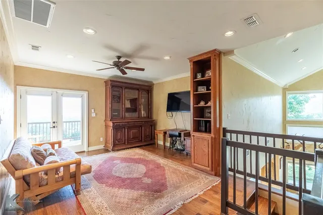 a living room with furniture a window and a chandelier