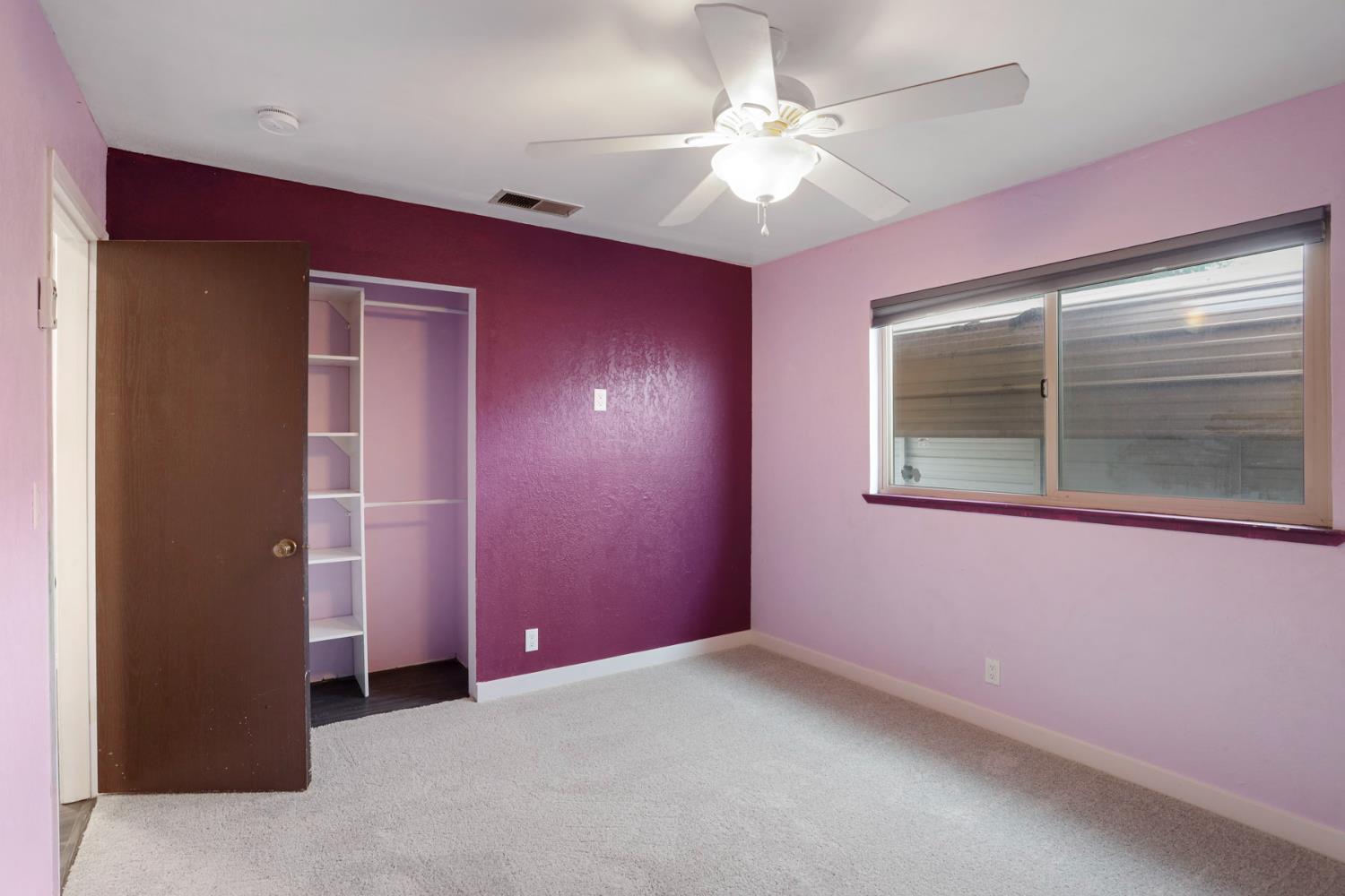 2443 Fern Street Merced, CA 95348 - Photo 19 of 50 en empty room with windows and fan