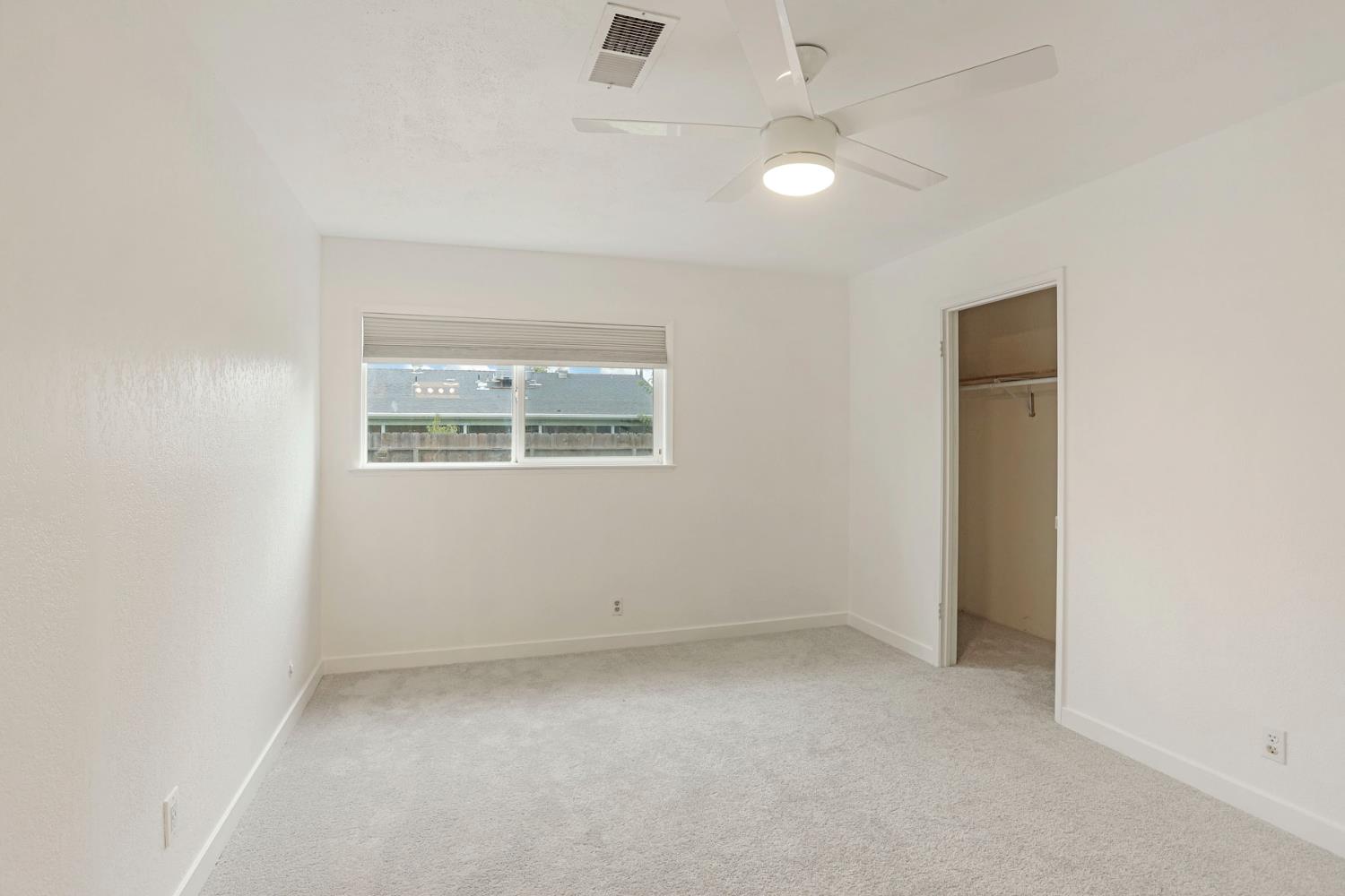 2443 Fern Street Merced, CA 95348 - Photo 22 of 50 an empty room with a window and a fan