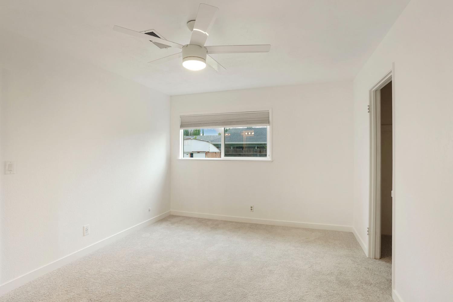 2443 Fern Street Merced, CA 95348 - Photo 23 of 50 an empty room with a window and a fan