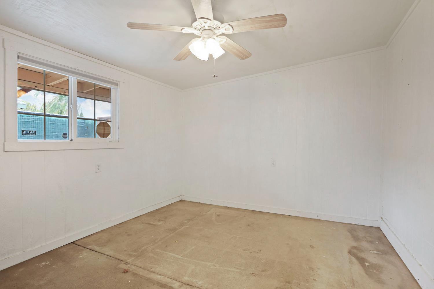 2443 Fern Street Merced, CA 95348 - Photo 27 of 50 an empty room with a window and a fan