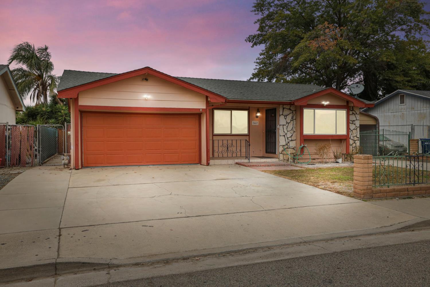 2443 Fern Street Merced, CA 95348 - Photo 3 of 50 a front view of a house with a yard and garage