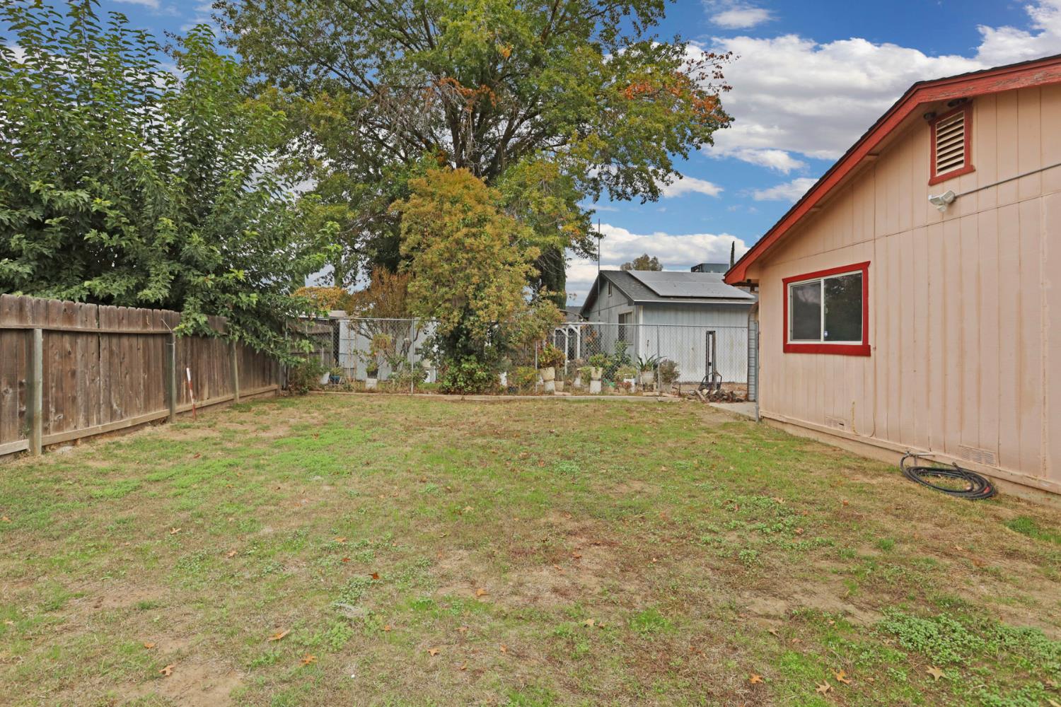 2443 Fern Street Merced, CA 95348 - Photo 34 of 50 a front view of house with yard and trees in the background
