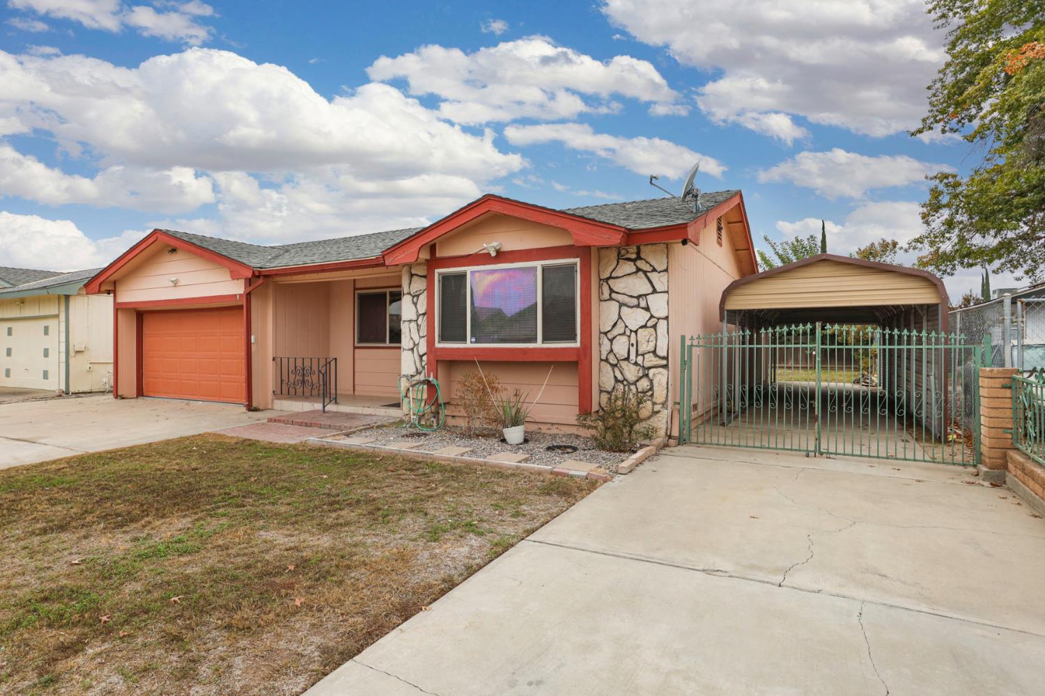 2443 Fern Street Merced, CA 95348 - Photo 4 of 50 a front view of a house with garden