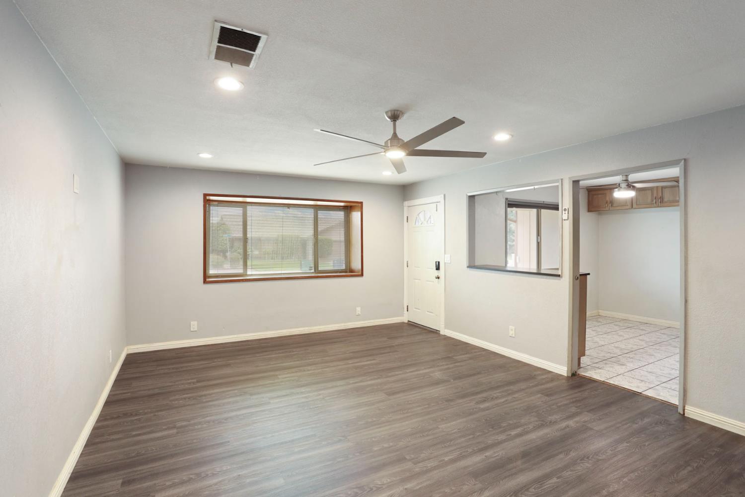 2443 Fern Street Merced, CA 95348 - Photo 8 of 50 wooden floor in an empty room with a window