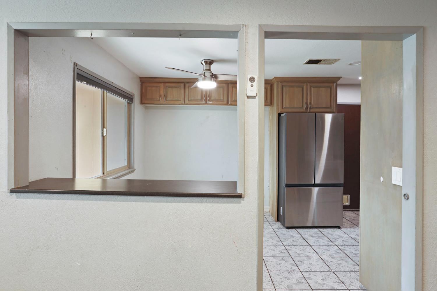 2443 Fern Street Merced, CA 95348 - Photo 9 of 50 a view of a refrigerator in kitchen and a refrigerator in a kitchen