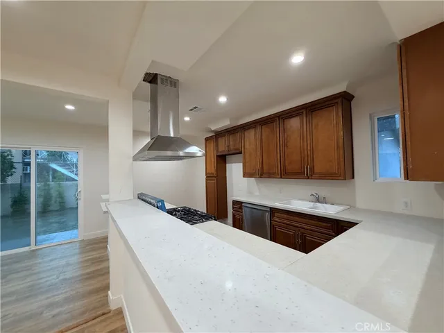 a open kitchen with kitchen island a sink stainless steel appliances and cabinets