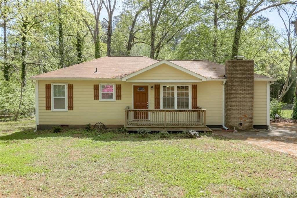 6395 Lobelia Road Southwest Mableton, GA 30126 - Photo 1 of 1 a house with trees in the background
