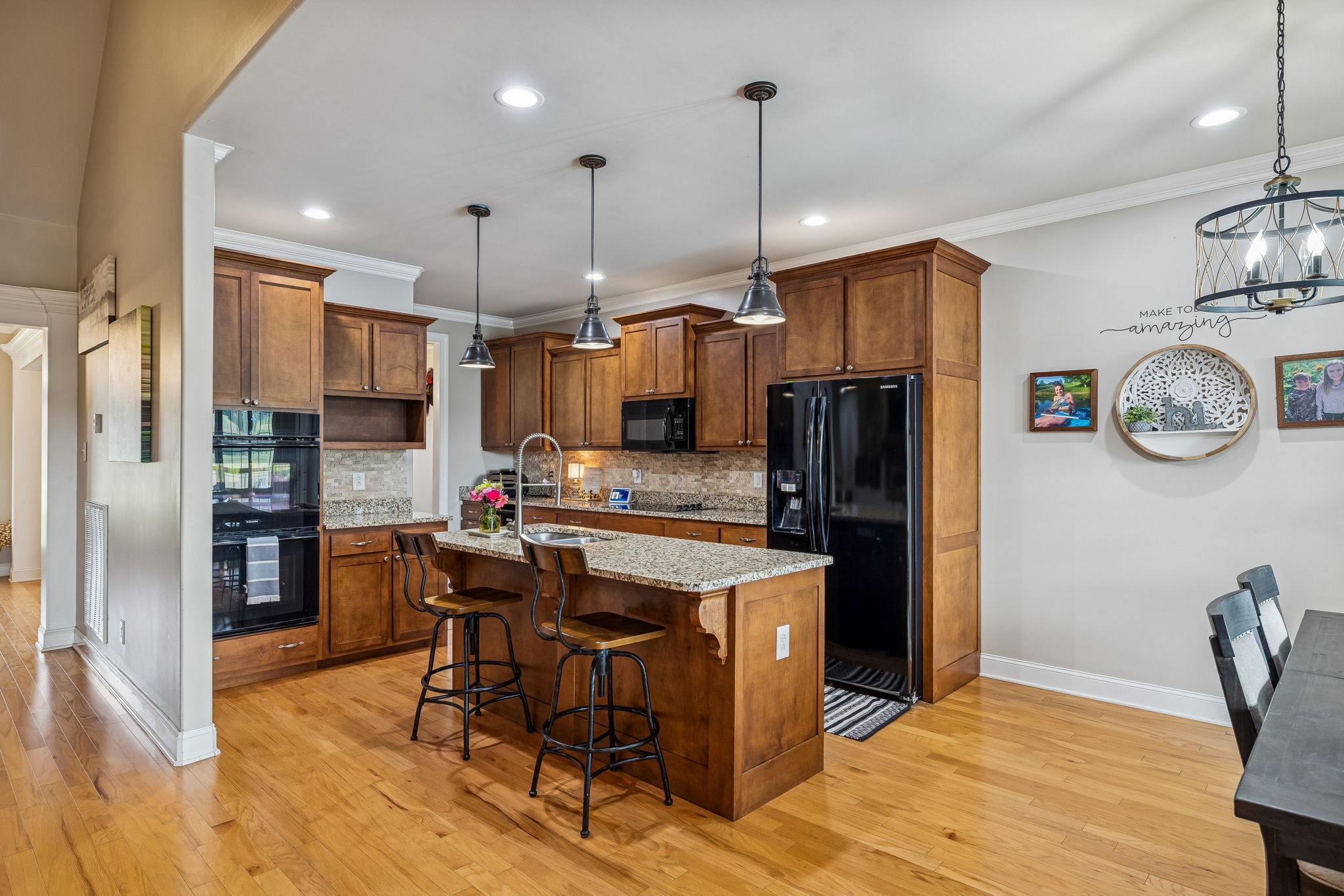 2845 Anes Station Road Lewisburg, TN 37091 - Photo 18 of 70 a kitchen with stainless steel appliances kitchen island granite countertop a refrigerator a oven a sink a dining table and chairs with wooden floor