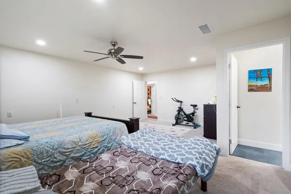 a bathroom with a double vanity sink mirror and toilet