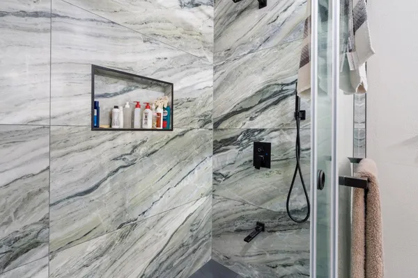 a bedroom with a bed and a ceiling fan