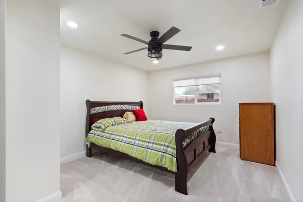 a spacious bathroom with a toilet a sink and mirror